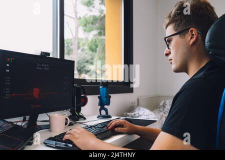 young man working as a graphic designer from home on his computer. Stock Photo
