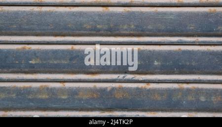 Gray and blue metal siding door close up with horizontal lines for background texture Stock Photo