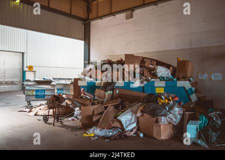 Packed garbage container in a warehouse Stock Photo