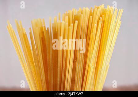 Raw or uncooked pasta with a white background, side view horizontal shot. Stock Photo