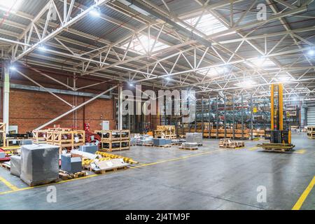 Distribution warehouse or logistic center with goods and cargos in boxes ready for shipment and delivery transportation. Stock Photo