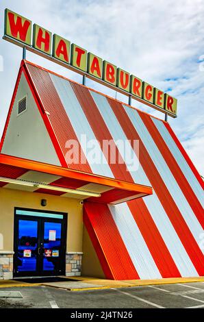 Whataburger’s classic A-frame restaurant is pictured, April 15, 2022, in Mobile, Alabama. The American fast-food chain was founded by Harmon Dobson. Stock Photo
