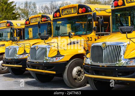 Rothsville, PA, USA - April 17, 2022: A fleet of parked yellow school buses in a rural village in Lancaster County, Pennsylvania. Stock Photo