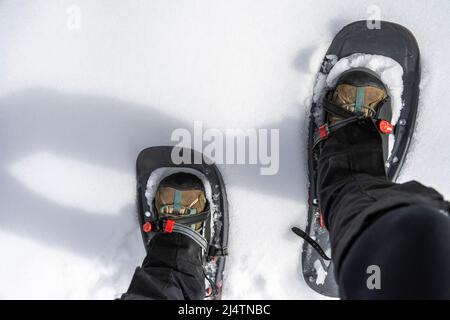 point of view image of a person walking in snowshoes Stock Photo