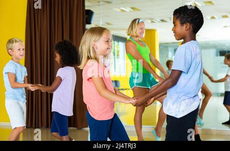 Positive little boys and girls dancing pair dance in the ballet studio Stock Photo