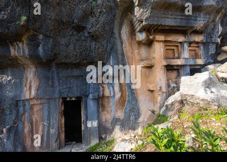 Lycian rock hewn tombs carved into mountainside in Pinara, Turkey Stock Photo