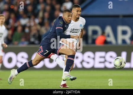 Paris, France. 17th Apr, 2022. Paris Saint Germain's Kylian Mbappe (L) vies with Marseille's William Saliba during a French Ligue 1 football match between Paris Saint Germain (PSG) and Marseille in Paris, France, April 17, 2022. Credit: Gao Jing/Xinhua/Alamy Live News Stock Photo