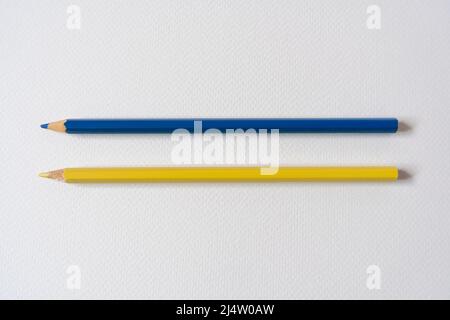 Blue and yellow colored pencils on paper Stock Photo