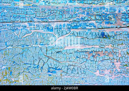 Cracked blue and yellow paints on old wooden wall. Abstract grunge vintage rustic texture.  Stock Photo