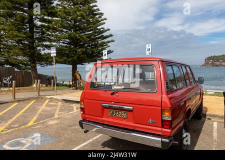 Red 1986 model Toyota Landcruiser, classic four wheel drive vehicle parked at Avalon Beach in Sydney,NSW,Australia Stock Photo