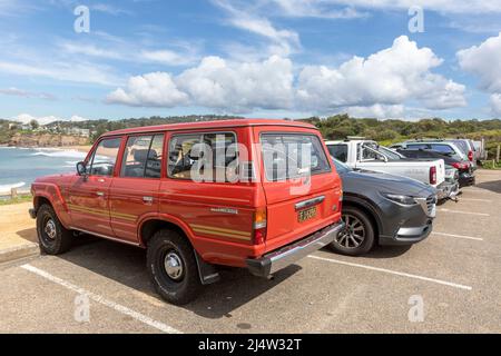 Red 1986 model Toyota Landcruiser, classic four wheel drive vehicle parked at Avalon Beach in Sydney,NSW,Australia Stock Photo