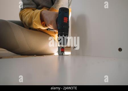Close up of woman hand using cordless screwdriver Stock Photo