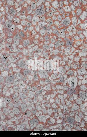 Close up orange, gray and white mosaic stone wall in Bali, Indonesia Stock Photo