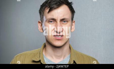 Depressed young man feels stressed and desperate. Stock Photo