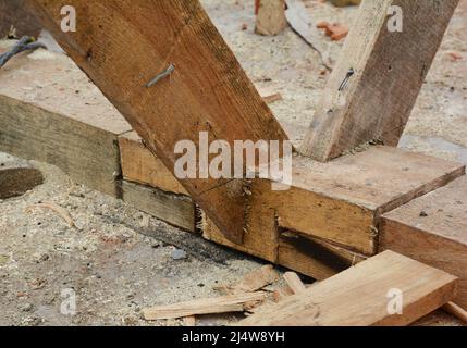 Roofing construction on the stage of roof framing. A close-up of trusses, rafters, roof beams joining together, attached to the top plate. Stock Photo