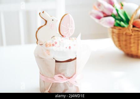 Cookies in the form of rabbit and an egg on easter cake tied with bow Stock Photo