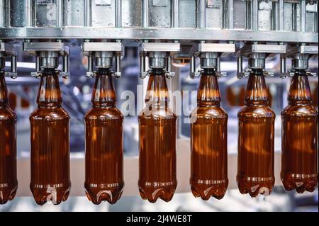 Automatic filling machine, the process of filling plastic bottles with various drinks Stock Photo