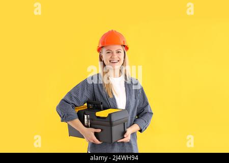 Concept of professions, young woman on yellow background Stock Photo