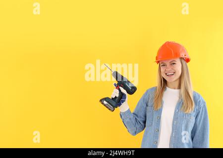 Concept of occupation, young woman on yellow background Stock Photo
