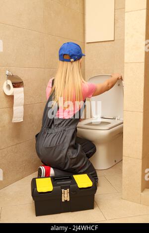 Concept of occupation, young woman plumber in uniform Stock Photo
