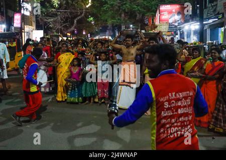 People carrying offerings during a religious festival and watch dancers performing in Trichy, Tamil Nadu, India Stock Photo