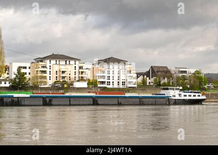 Koblenz, Germany – April 2022: Industrial barge transporting shipping containers on the Moselle River. Stock Photo