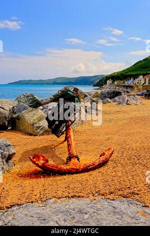 An old rusty Anchor on the beach at Beesands Stock Photo