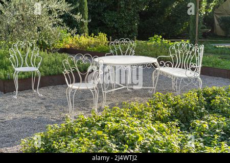 Classic white garden furniture in a garden Stock Photo