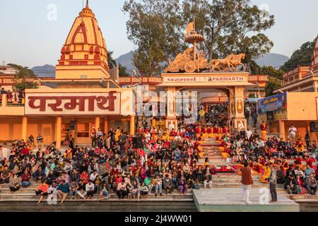 hindu temple filled with crowed at evening form religious prayer image is taken at parmarth niketan rishikesh uttrakhand india on Mar 15 2022. Stock Photo