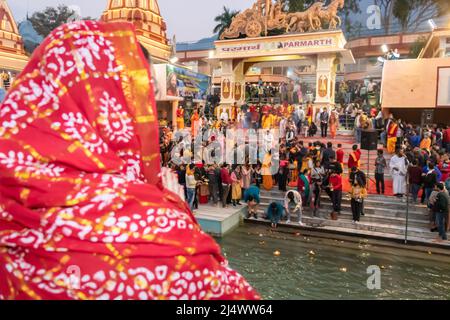 devotee doing ganga aarti pryer at evening at hindu temple image is taken at parmarth niketan rishikesh uttrakhand india on Mar 15 2022. Stock Photo