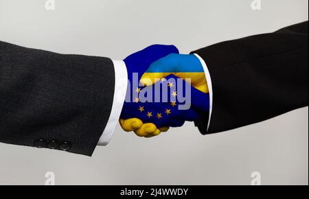 Cooperation and business, handshake with two flags. Men handshake with the EU and Ukraine flag. Support concept Stock Photo