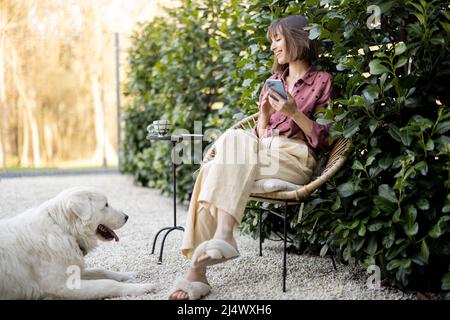 Happy woman with her dog at backyard Stock Photo