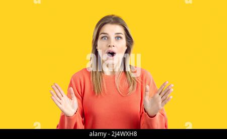 Portrait of surprised and amazed young woman looking at you with wide open mouth and big eyes. Stock Photo