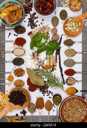 Selection of herbs and cooking spices on spoons. Stock Photo