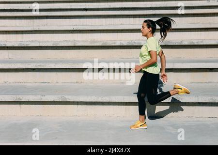 Attractive brunette doing active exercises on steps Stock Photo