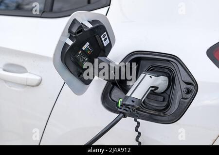 Close up of electric cable attachment for electric car being charged at car charging point, United Kingdom Stock Photo