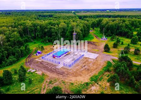 Natural gas distribution station of main gas pipeline. View from above. Type of gasification object on summer day. Construction of gas pipeline. Stock Photo