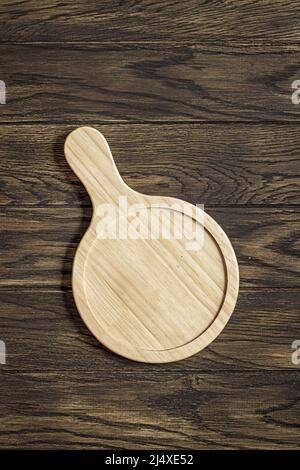 Small tray with handle on oak wooden table top view Stock Photo