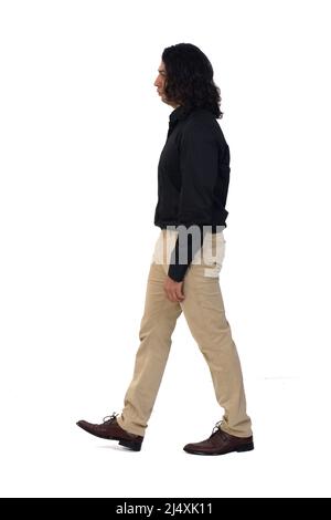 side view of a man with long hair walking white background Stock Photo