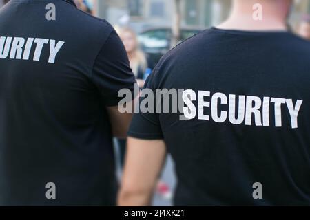 two security guards standing on street Stock Photo