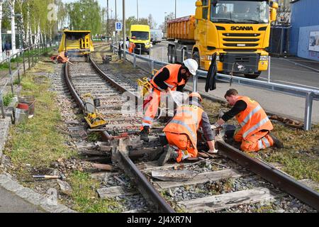 Basel, Switzerland - April 2022: Railway workers repairing track on a railway line in the city's docks area Stock Photo