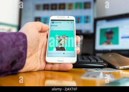 Belgrade, Serbia - April 15, 2022: Popular and expensive Bored Ape NFT from Yacht Club NFT collection (BAYC) on smartphone screen. Trading at Opensea Stock Photo