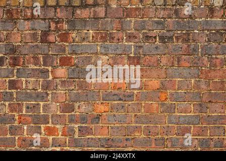 Old weathered red brick wall closeup as background Stock Photo