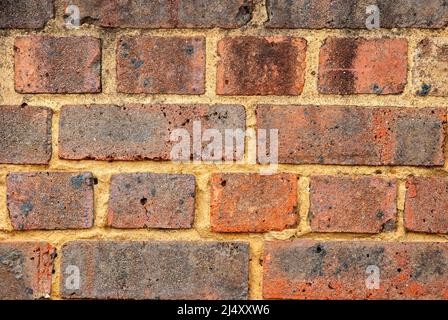 Old weathered red brick wall closeup as background Stock Photo