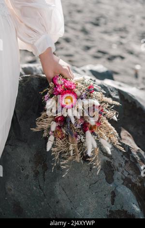 The bride's bouquet lies on a stone Stock Photo