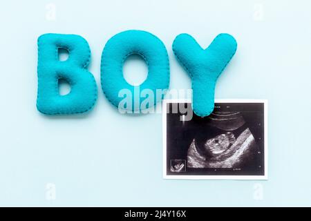 Ultrasound scan of unborn baby with letters boy Stock Photo