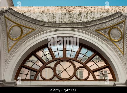 A semi circle window with wooden frame lines in a vintage style building. Stock Photo