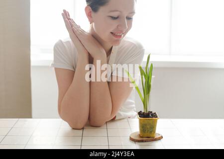 lovely housewife woman with flower in pot. Gardening, holidays, Spring and Easter concept. Stock Photo