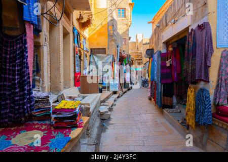Jaisalmer, Rajasthan, India - October 13, 2019 : Colourful ladies clothes are displayed for sale to tourists in market place Inside Jaisalmer Fort. Stock Photo