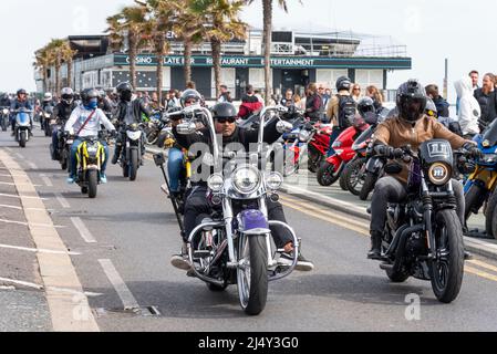 Southend on Sea, Essex, UK. 18th Apr, 2022. The 'Southend Shakedown' has for many years been a regular Easter Bank Holiday Monday gathering at the seafront location, attracting many thousands of motorcyclists for their first big ride-out of the year - hence 'shakedown'. Back after a break for COVID the event enjoyed the good weather of the Easter weekend. Riders passing rows of parked bikes on seafront Stock Photo